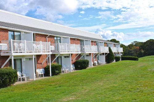 a building with a lawn in front of it at Cape Cod Irish Village - The Emerald Resort in Barnstable