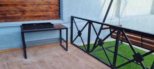 a black table next to a balcony with green grass at Aframezing Gabala in Gabala