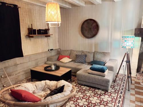 a living room with a couch and a table at D'une rive à l'autre in Francueil