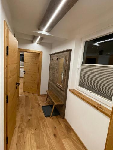 a room with a door and a window and a wooden floor at Pension und Apartment Edelweiß in Heiligenblut