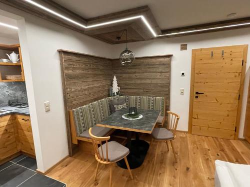 a dining room with a table and chairs at Pension und Apartment Edelweiß in Heiligenblut