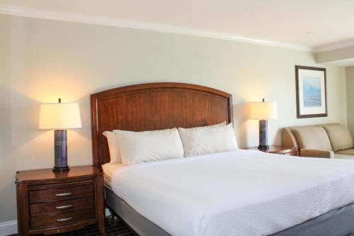 a bed in a hotel room with two lamps at Cape Cod Irish Village - The Emerald Resort in Barnstable