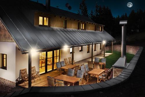 an aerial view of a house with a deck at night at Penzion Na Začátku in Benecko
