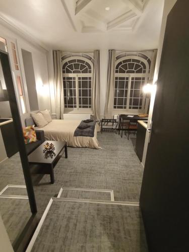 a living room with a bed and a couch at Le 12 wifi neuf app 01 in Saint-Étienne