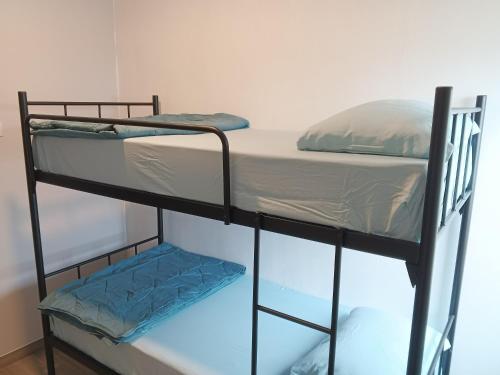 a couple of bunk beds in a room at Formosa Spacious Apartments with Netflix & Pick Up Service by MESA in Nagoya