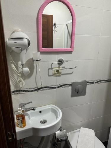 a bathroom with a sink and a mirror and a toilet at Reggae in Istanbul