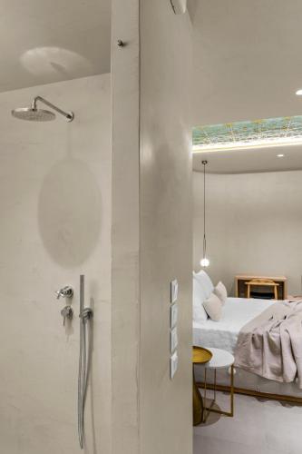 a bedroom with a bed and a shower in a room at ACRON 12 penthouse Acropolis suites in Athens