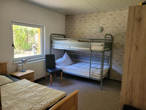 a bedroom with two bunk beds and a window at Waldblick in Marlow