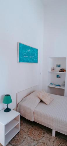 a bedroom with two beds and a lamp on a table at Villa dei fiori B&B in Capri