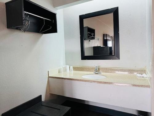 a bathroom with a sink and a mirror at Motel 6-Cedar Rapids, IA in Cedar Rapids