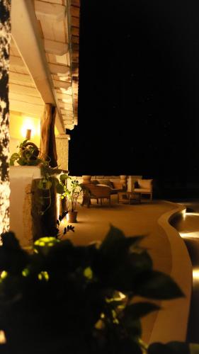 a nighttime view of a patio at night at Villa Agostina in Murta Maria