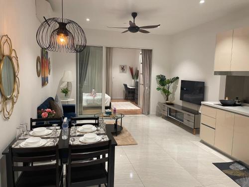a kitchen and a living room with a table and chairs at Quill Residences A&P KLCC in Kuala Lumpur