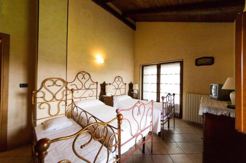 Postel nebo postele na pokoji v ubytování Agriturismo La Ca 'd Majin