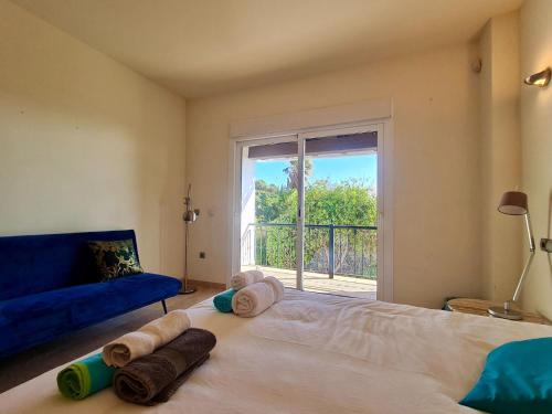 a bedroom with a large bed with towels on it at Villa Pugna - Private Pool, BBQ, Sauna in Benalmádena