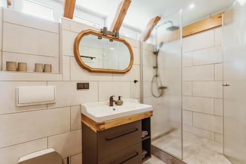 a bathroom with a sink and a shower at Pension Goldbachmühle in Blankenburg