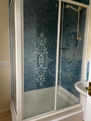 a shower with a glass door in a bathroom at The Island View in Berwick-Upon-Tweed