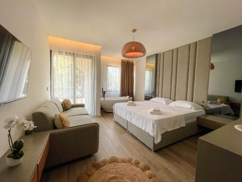 a living room with a bed and a couch at Botanica Boutique Hotel in Ulcinj