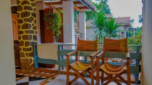 a table and two chairs on a porch at Lushoto views cottage in Lushoto