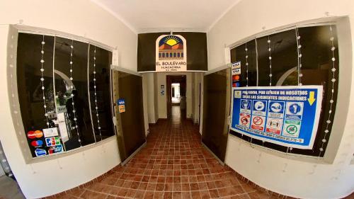 a hallway in a building with a sign on the wall at El Boulevard de Huacachina in Ica