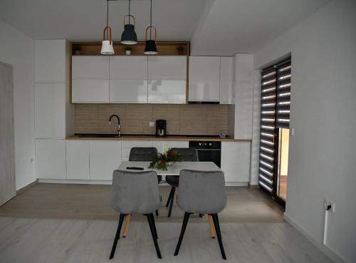 a kitchen with a table and two chairs at Apartament Eva in Cristian