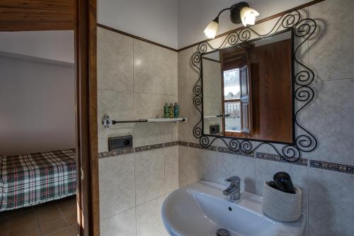 a bathroom with a sink and a mirror at Nastura Casa Rural L'Art in Rupit
