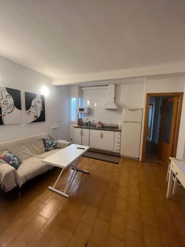 a living room with a couch and a table at Apartamentos Rincón del Roldán - La Rinconada in San Jose de la Rinconada