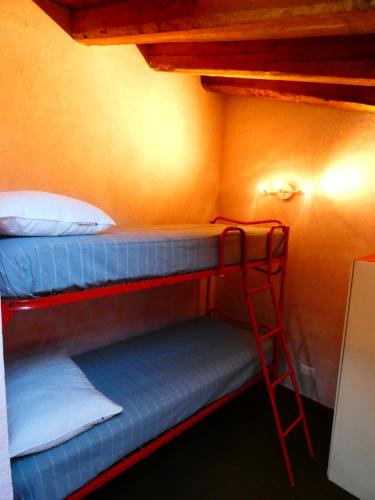 a room with two bunk beds and a ladder at Le Coucou de Thovex in Morgex