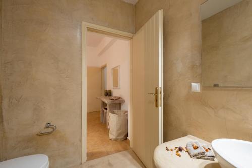a bathroom with a toilet and a sink at White Orchid Villa in Pyrgos