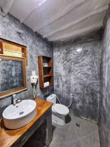 a bathroom with a sink and a toilet at Aya Beach Resort in Kizimkazi