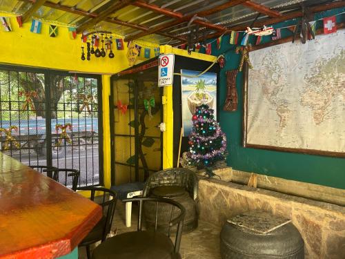 a restaurant with a christmas tree in the corner at Coco Hotel and Hostel in Sosúa