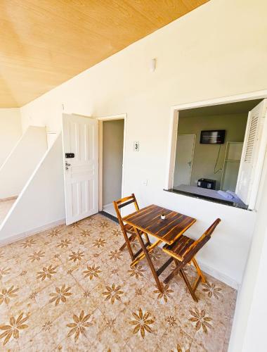 a dining room with a table and two chairs at JF Studio Hotel in São Luís