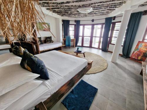 a living room with a bed and a couch at Aya Beach Resort in Kizimkazi