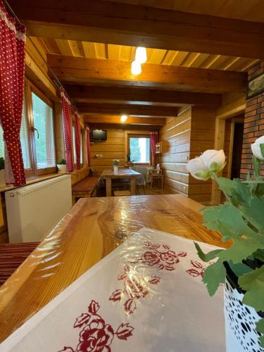 a large room with a wooden table in a house at Villa Milan in Tatranská Lomnica