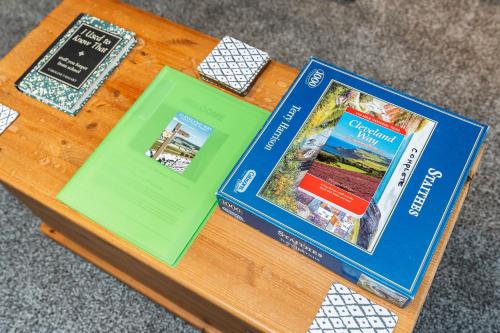 three books sitting on top of a wooden table at The Cleveland Way, North Yorkshire in Loftus