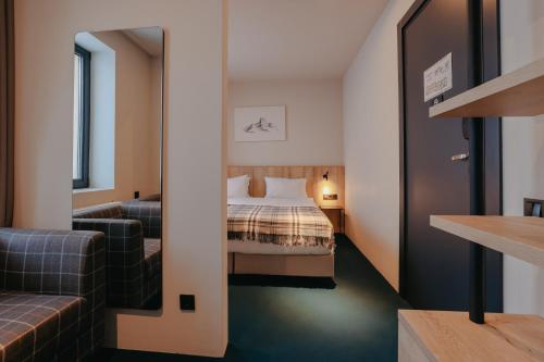 Postel nebo postele na pokoji v ubytování Alpina Hotel