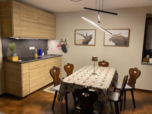 a kitchen with a table and some chairs and a kitchen with a table at Les Arnauds in Bardonecchia
