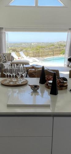 a table with wine glasses on a counter in a kitchen at GrottoOnTheRocks in Grotto Bay