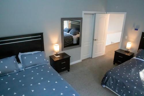 a bedroom with two beds and a mirror at Spectacular home with a amazing ocean - river view in Groton