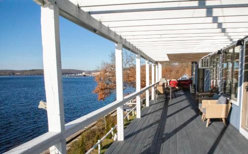 a balcony of a house with a view of the water at Spectacular home with a amazing ocean - river view in Groton