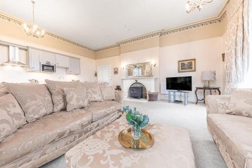 a living room with a couch and a fireplace at 1 Brathay Fell in Ambleside