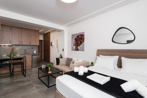 a bedroom and living room with a bed and a kitchen at LP Citycenter Suite in Serres