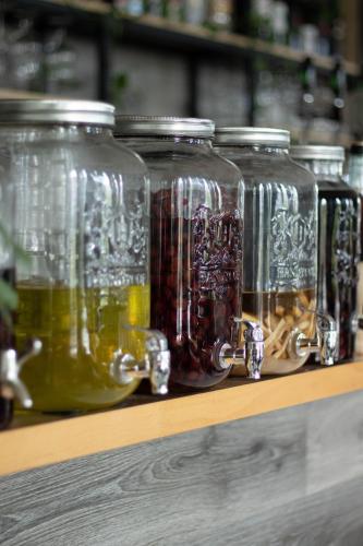 a row of glass jars sitting on a shelf at Готельно-ресторанний комплекс Фамілія in Bushtyno