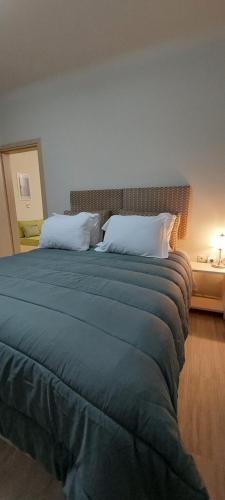 a bedroom with a large bed with two pillows at Votrishouse in Fira