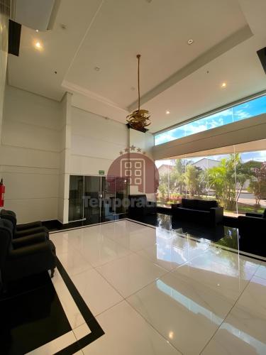 a living room with a couch and a large window at Piazza diRoma com acesso ao Acqua Park - Luciana in Caldas Novas