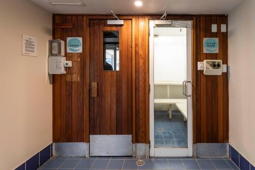 a room with a wooden door in a room at Gia Sydney in Sydney