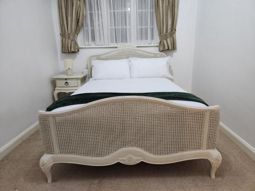 a white bed in a room with a window at Elmdon House with 4 Spacious Bedrooms to choose in Birmingham