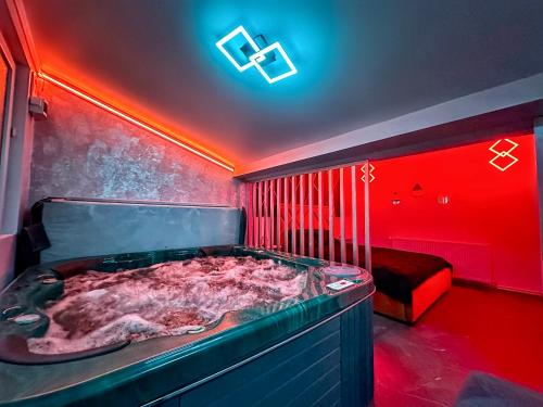 a room with a jacuzzi tub in a bedroom at Luxor - Jacuzzi&Cozy Apartments in Sibiu
