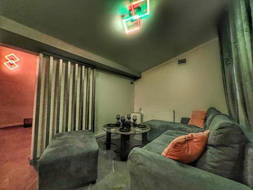 a living room with a couch and a table at Luxor - Jacuzzi&Cozy Apartments in Sibiu