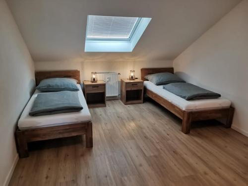 a bedroom with two beds and a skylight at Waldmohrer Hof in Waldmohr