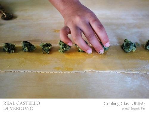 a person is placing food on a cutting board at Albergo Real Castello in Verduno